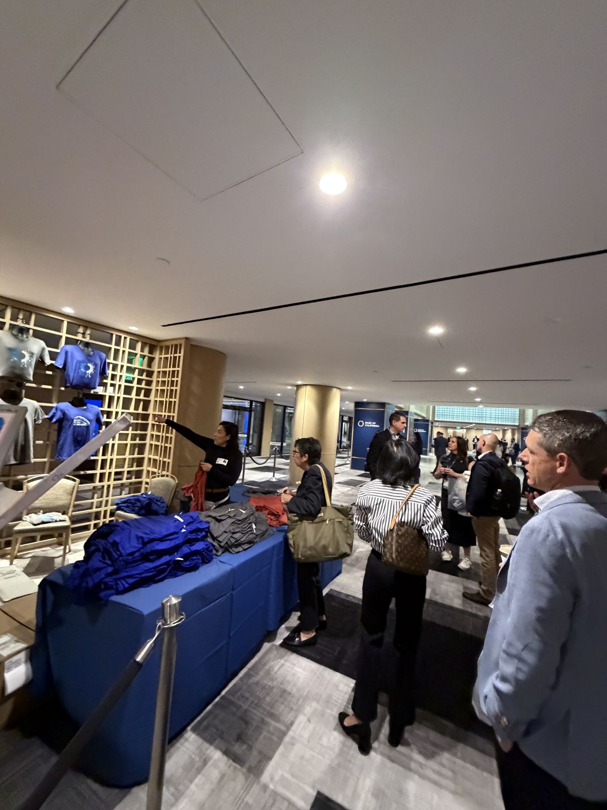 Guests watching custom merch get printed live at a Kansas City event